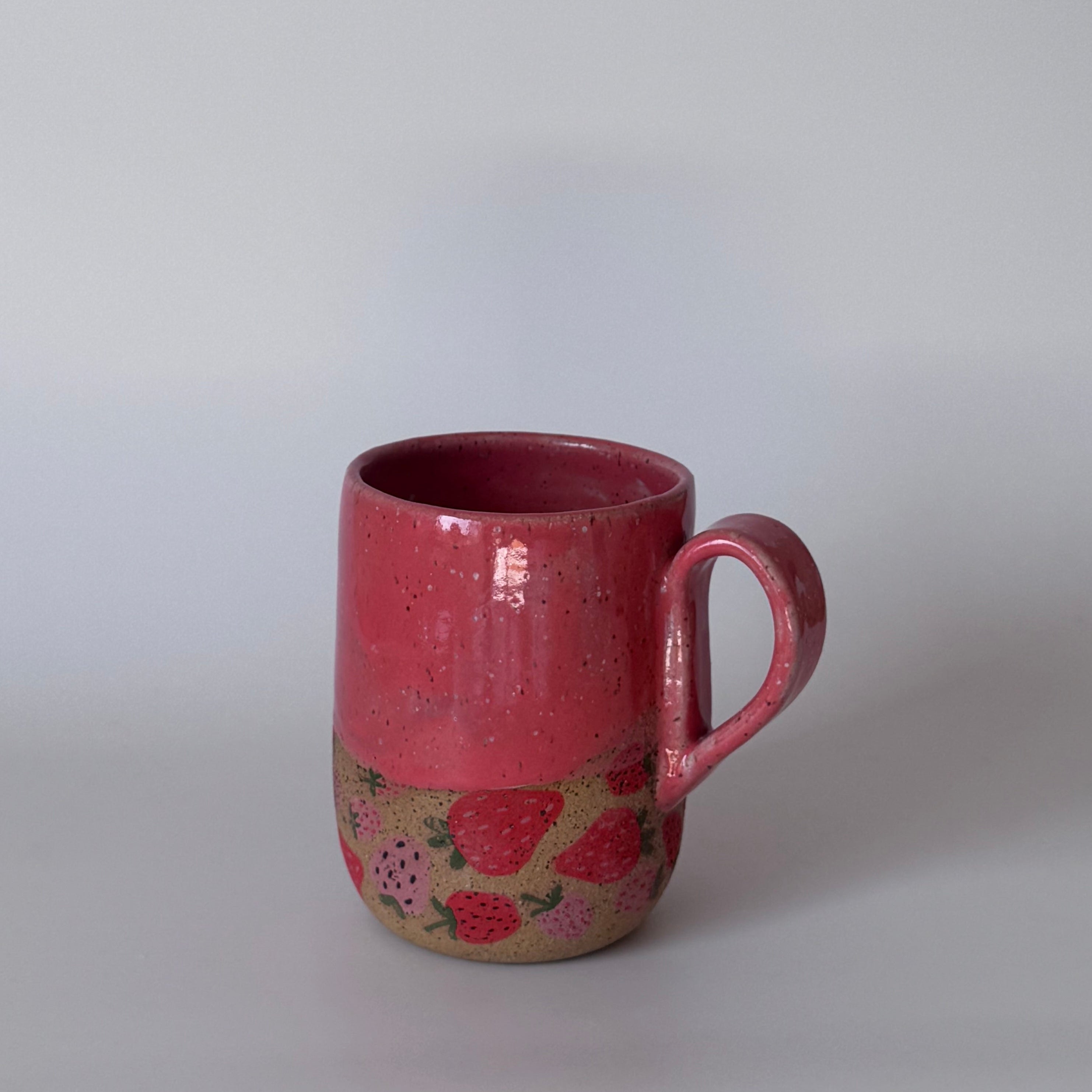 Red mug with floral design on a white background