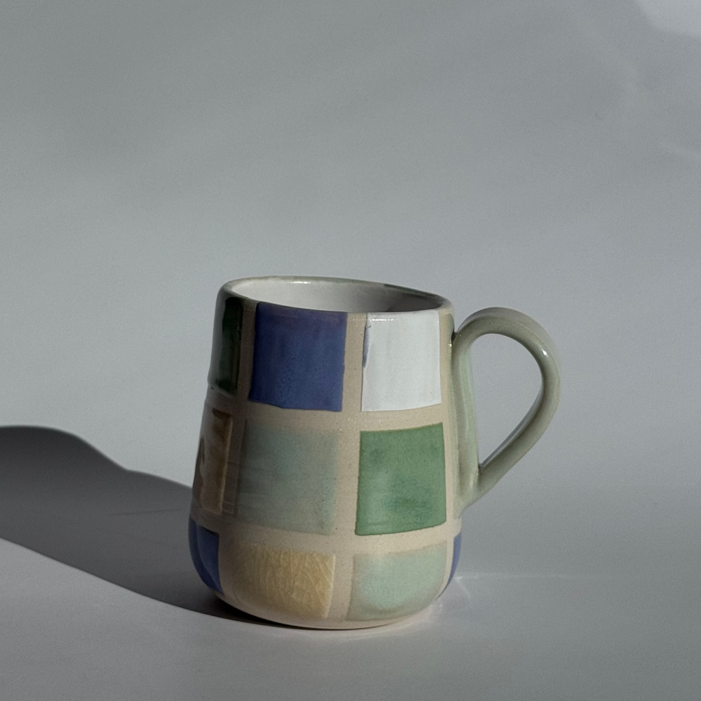 Ceramic mug with geometric pattern on a plain background