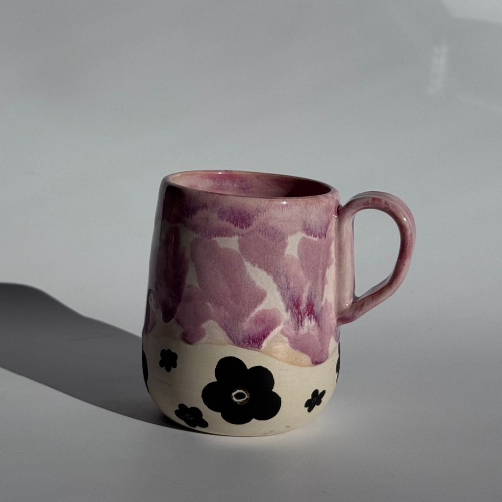 Ceramic mug with floral patterns on a white background